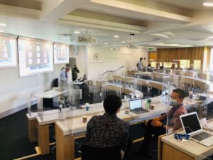 Desk top safety screens installed by Graphic Arts Group within a lecture theatre allow students to return to study